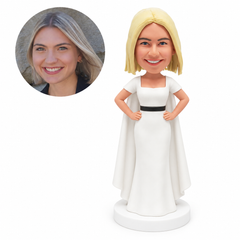 custom bobblehead figure woman in a white floor-length gown and cape with both hands on her hips