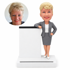 custom bobblehead figure businesswoman in a skirt suit beside an upright-panel business card stand