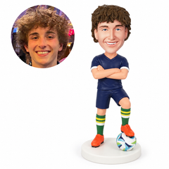 custom bobblehead figure male soccer player with crossed arms and one foot on the ball
