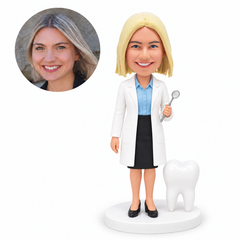 custom bobblehead figure female dentist holding a dental mirror beside a tooth model