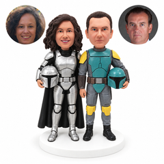 custom bobblehead figures couple in different space armor each holding a helmet with the woman wearing a cape