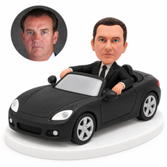 custom bobblehead figure businessman seated in a convertible with both hands resting on the doors