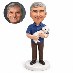 custom bobblehead figure man in a short-sleeved shirt cradling a small white dog