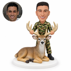 custom bobblehead figure man in camouflage standing behind a reclining deer