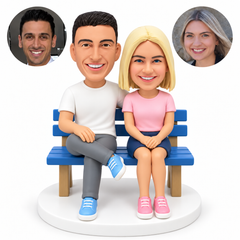 custom bobblehead figures couple seated on a bench with the man in a T-shirt and trousers and the woman in a T-shirt and short skirt