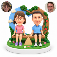custom bobblehead figures couple seated on a seesaw in front of a heart-shaped sky and tree backdrop