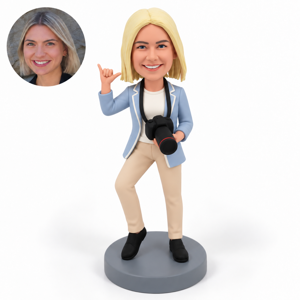 custom bobblehead figure female photographer making a shaka hand gesture while holding a neck-strap camera