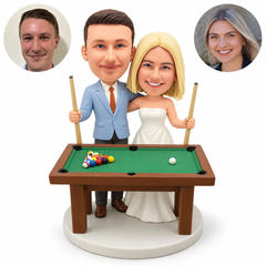 custom bobblehead figures wedding couple playing pool behind a full billiards table