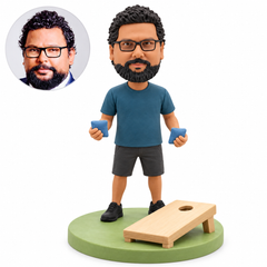 custom bobblehead figure cornhole player holding two bags beside a tilted board