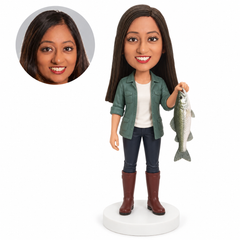 Custom female fisherwoman bobblehead holding a fish vertically in one hand
