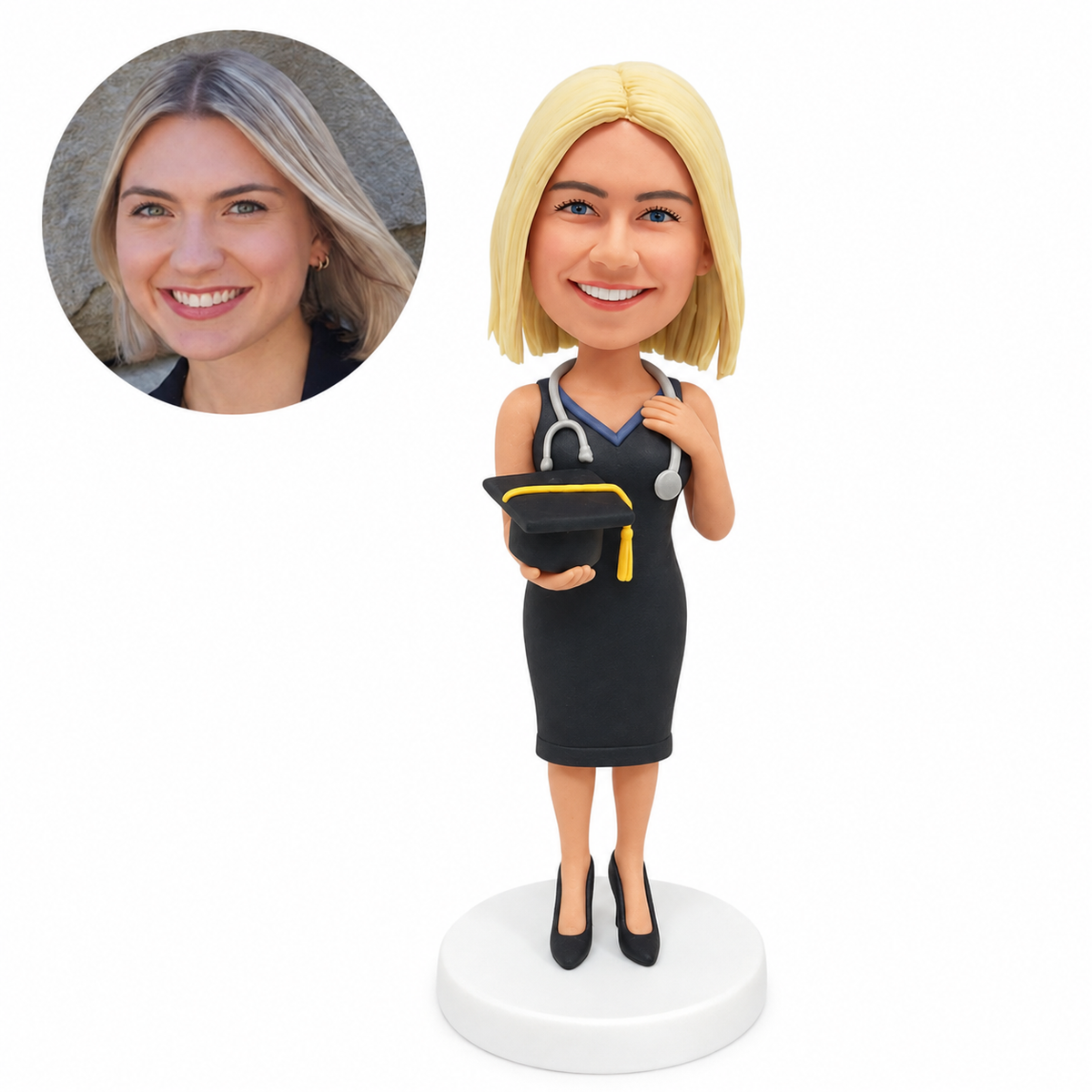 Custom female physical therapy graduate bobblehead in charcoal dress, holding graduation cap with stethoscope