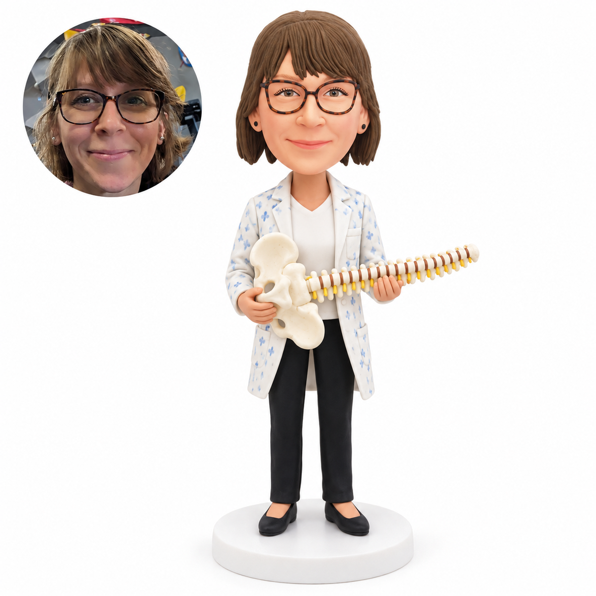 Personalized female chiropractor bobblehead holding a spine and pelvis model