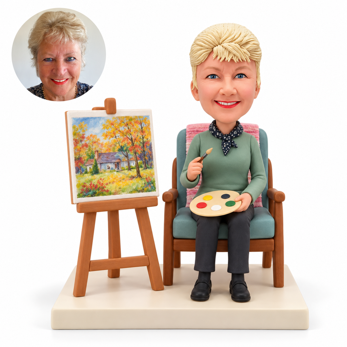 Older woman painter bobblehead seated with brush and palette beside an easel