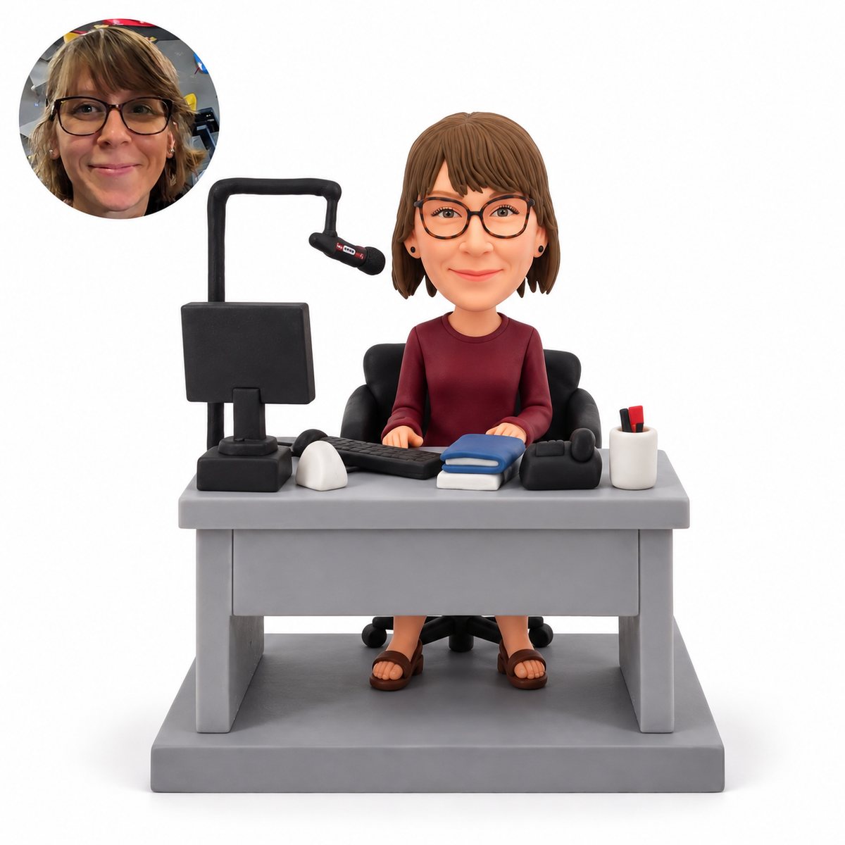 Custom female radio host clay bobblehead seated at a studio desk with monitor and microphone