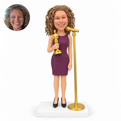 custom bobblehead figure woman holding an award trophy at a standing microphone