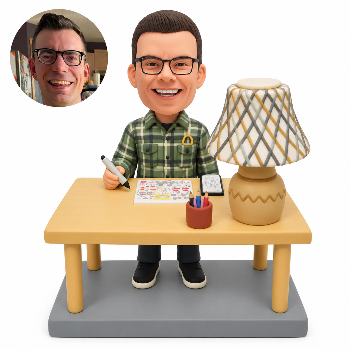 custom bobblehead figure male artist drawing at a worktable beside a large table lamp