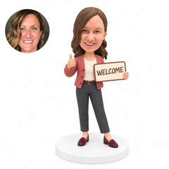 custom bobblehead figure woman holding a welcome sign and giving a thumbs up