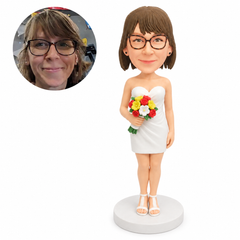 custom bobblehead figure bridesmaid in a strapless short dress holding a colorful bouquet