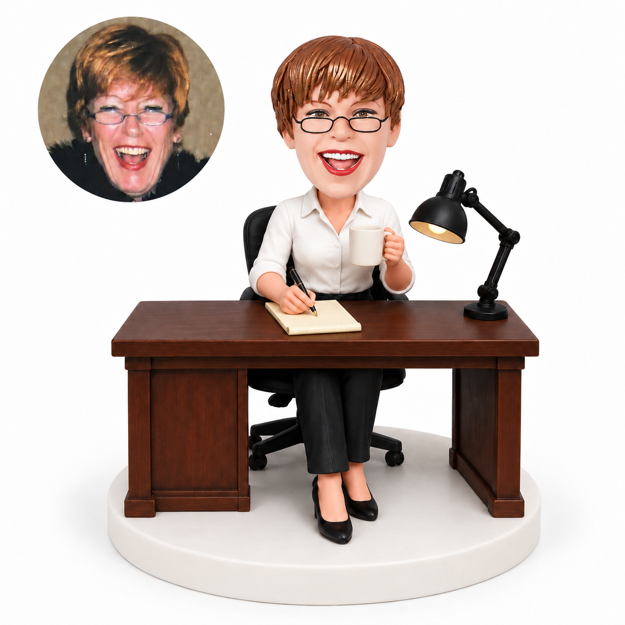 custom bobblehead figure woman writing at a desk while holding coffee beside a lamp