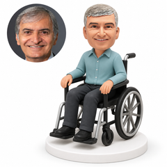custom bobblehead figure man in a casual long-sleeve shirt seated in a wheelchair with hands on the armrests